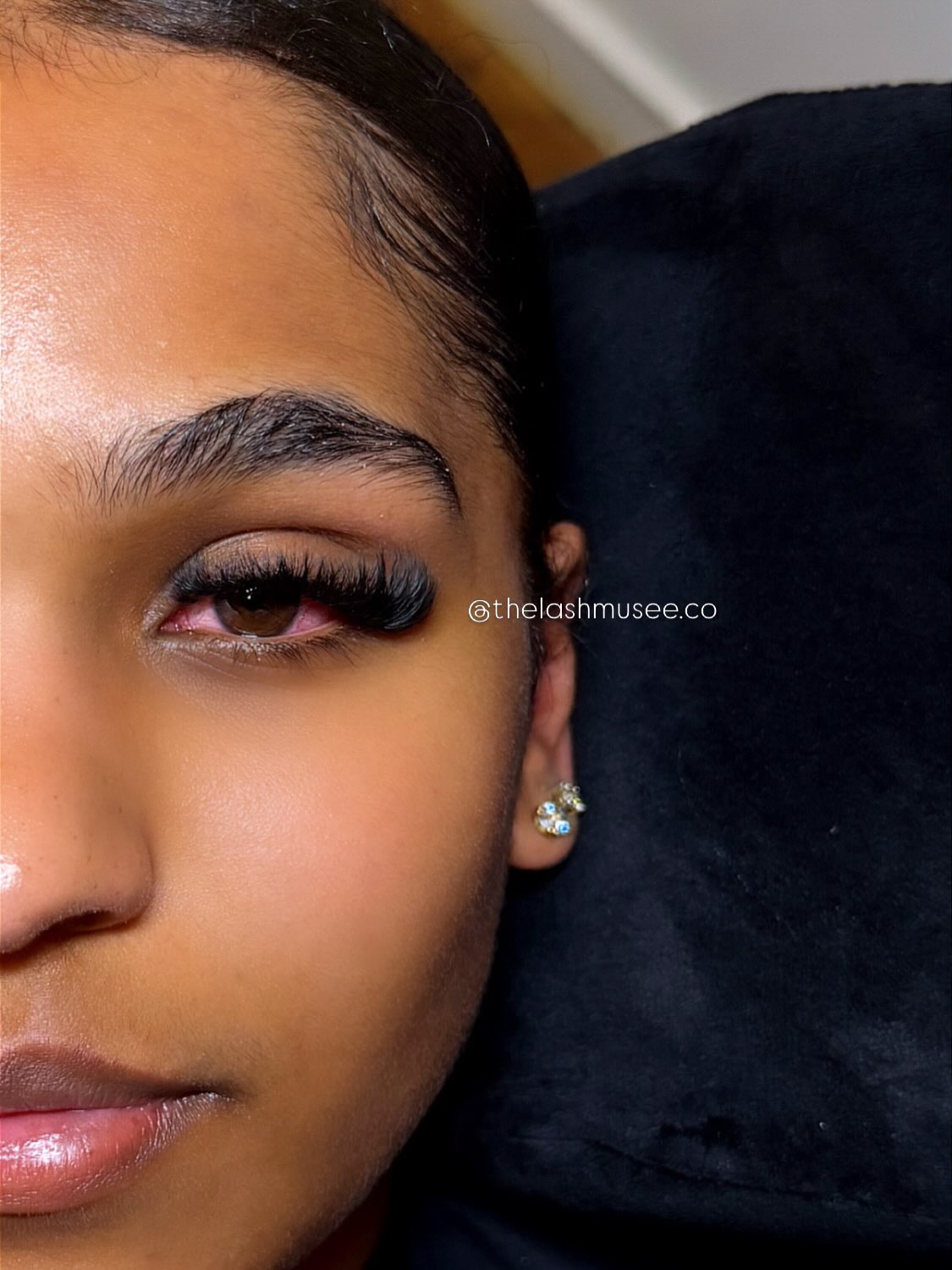 Half-face portrait showing a finished cat-eye lash set by The Lash Muse