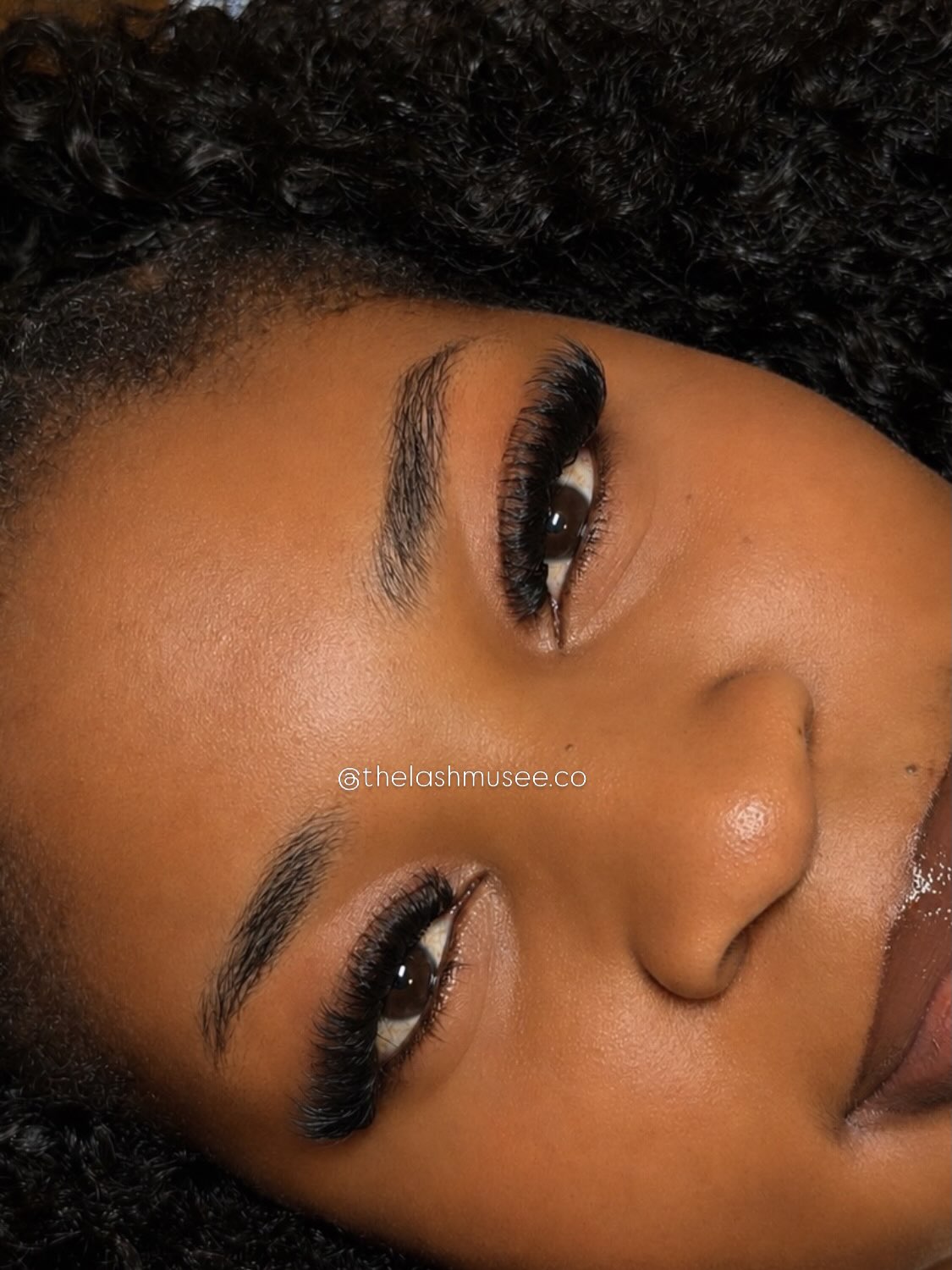 Sideways portrait showing a finished full lash set by The Lash Muse