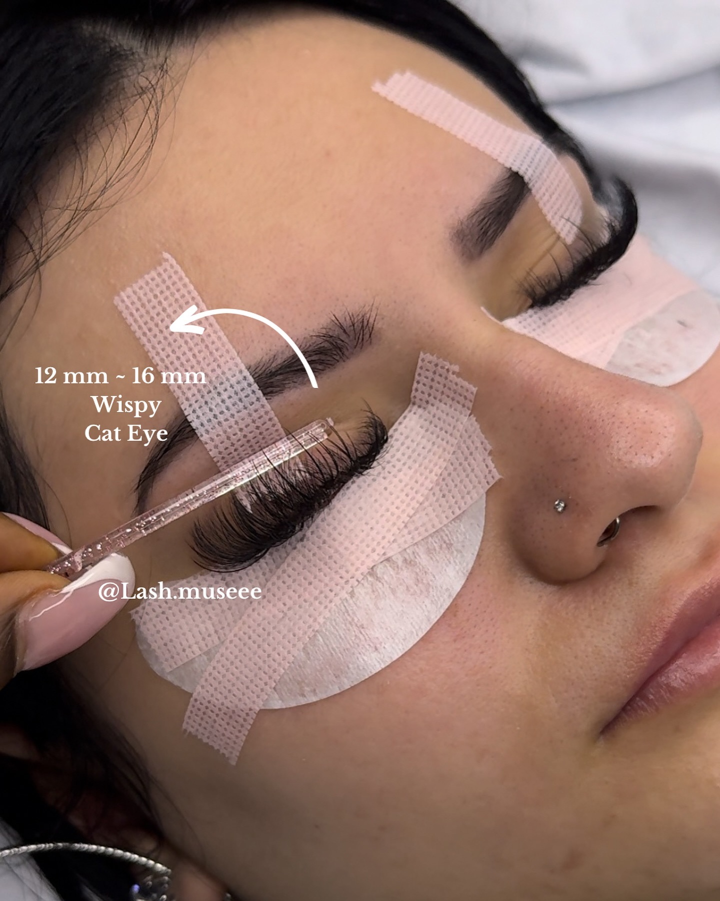 Wispy cat-eye lash application in progress